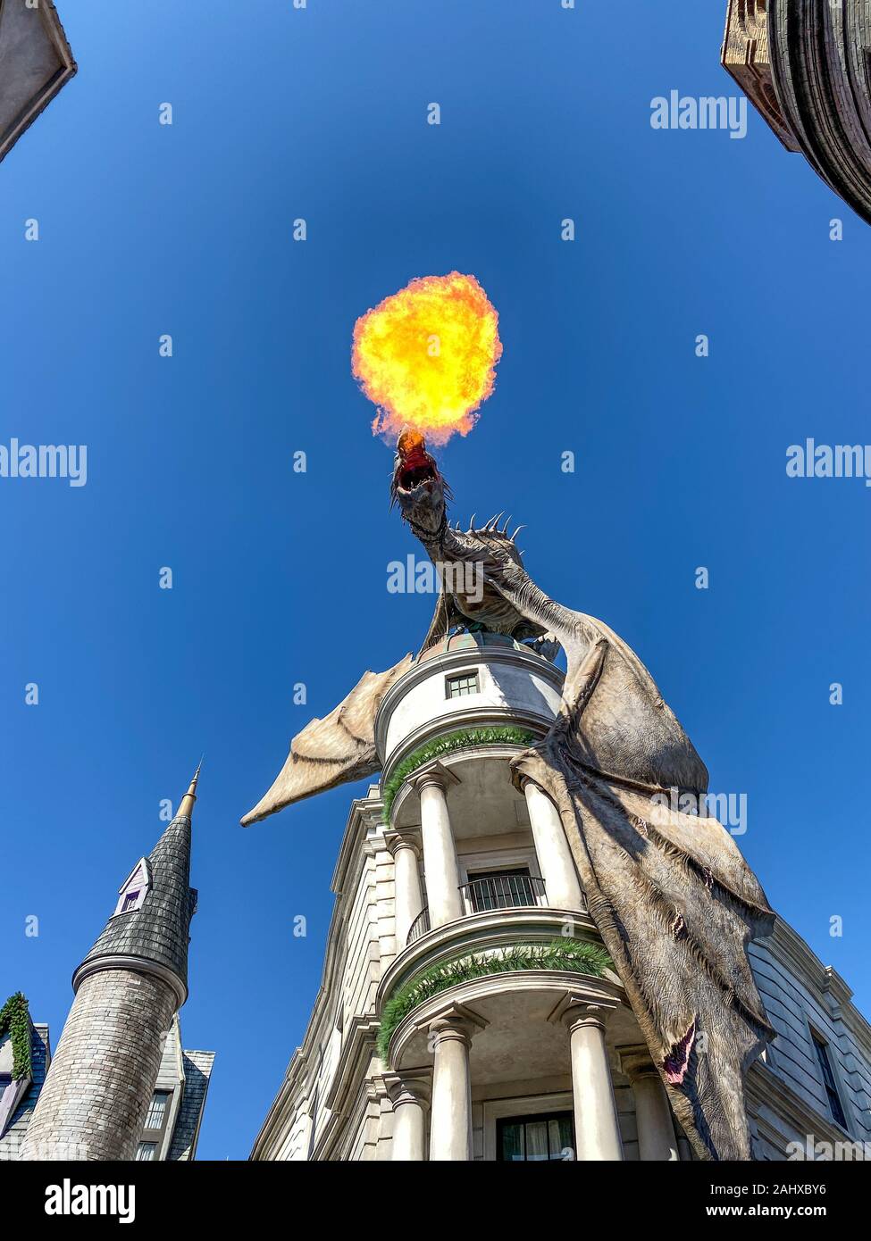 Orlando, FL/USA-11/30/19 : le dragon souffle ardent au-dessus de la banque Gringotts à Universal Studios à Orlando, Floride, par une belle journée ensoleillée. Banque D'Images