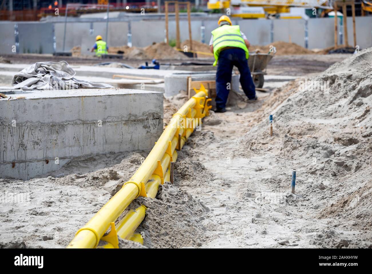 Tranchée avec le jaune pour les conduits de câble. Pose de câbles