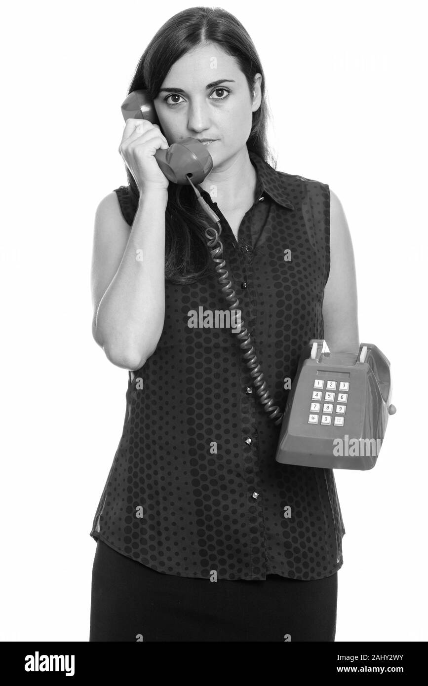 Studio shot of woman talking on old telephone Banque D'Images