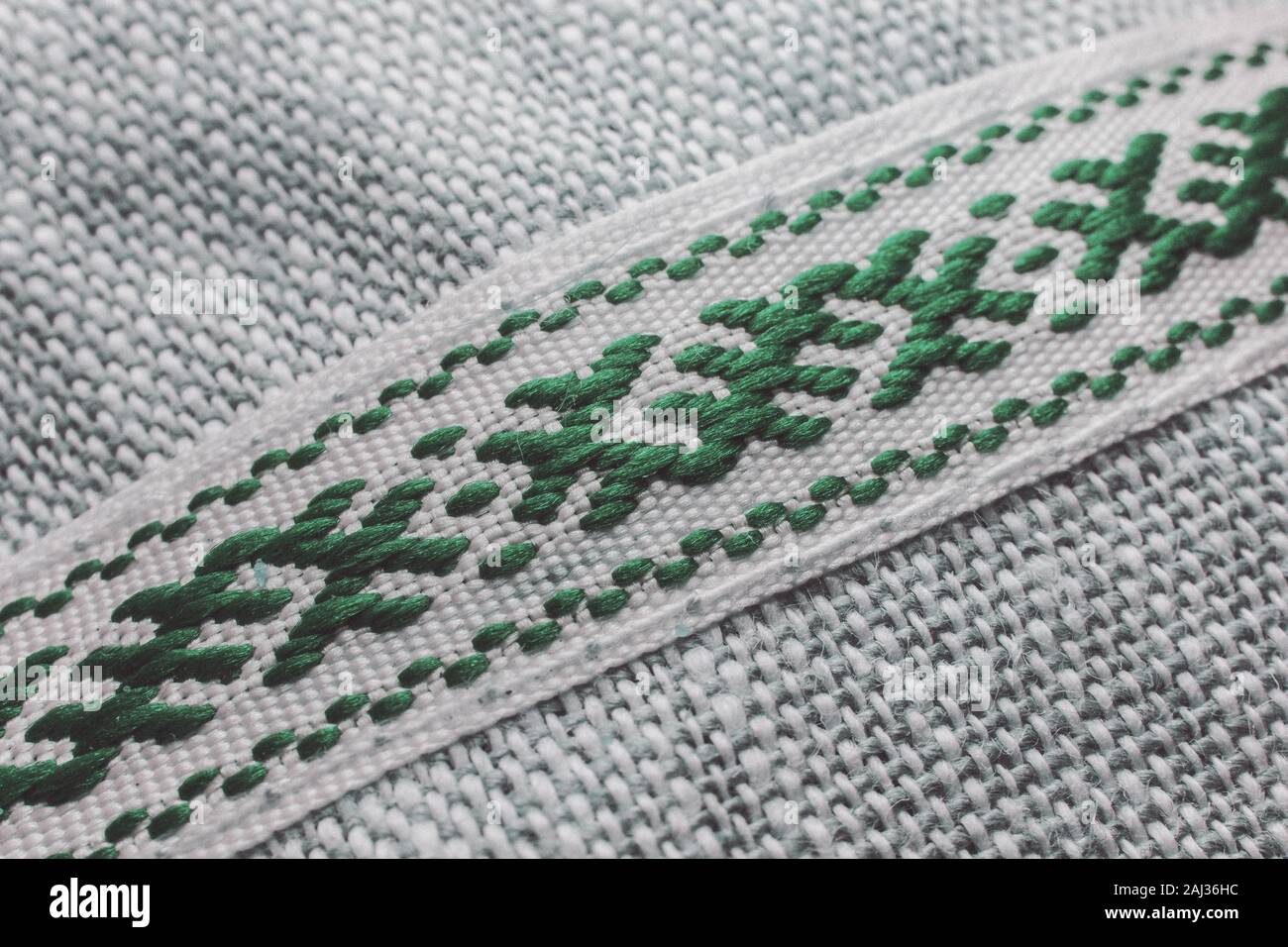 Close-up artistique traditionnel de tissu vert symbolique blanc combiné threads sur fond blanc en partie à la lutte Banque D'Images