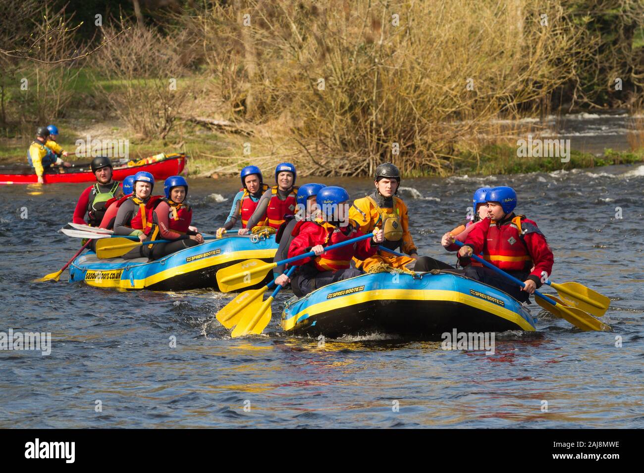Les personnes bénéficiant d'un team building de l'eau blanc aventure en rafting sur la rivière Dee dans le Nord du Pays de Galles Banque D'Images