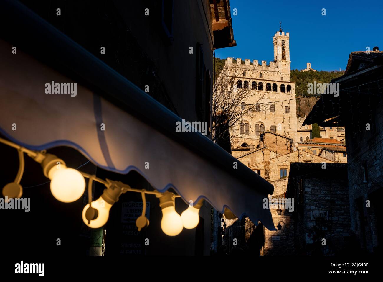 Vue sur le Palazzo dei Consoli de la rue Piccardi dans la lumière du coucher de soleil à Gubbio, une ville médiévale en Ombrie dans la province de Pérouse, I Banque D'Images