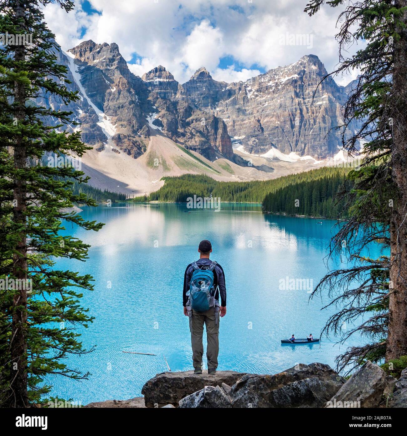 Randonneur admirant la vue en été au lac Moraine, dans le parc national Banff, Rocheuses canadiennes, l'Alberta, Canada. Banque D'Images