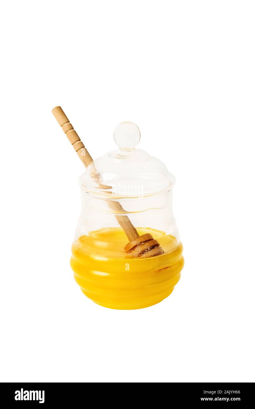 Pot de miel en verre avec balancier à l'isolé sur fond blanc Banque D'Images