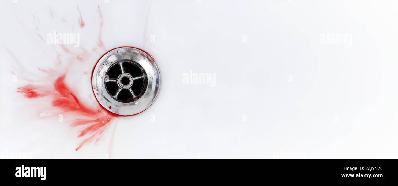 Sang et spit splatter dans un évier drains blanc. Image panoramique avec copie espace. Banque D'Images