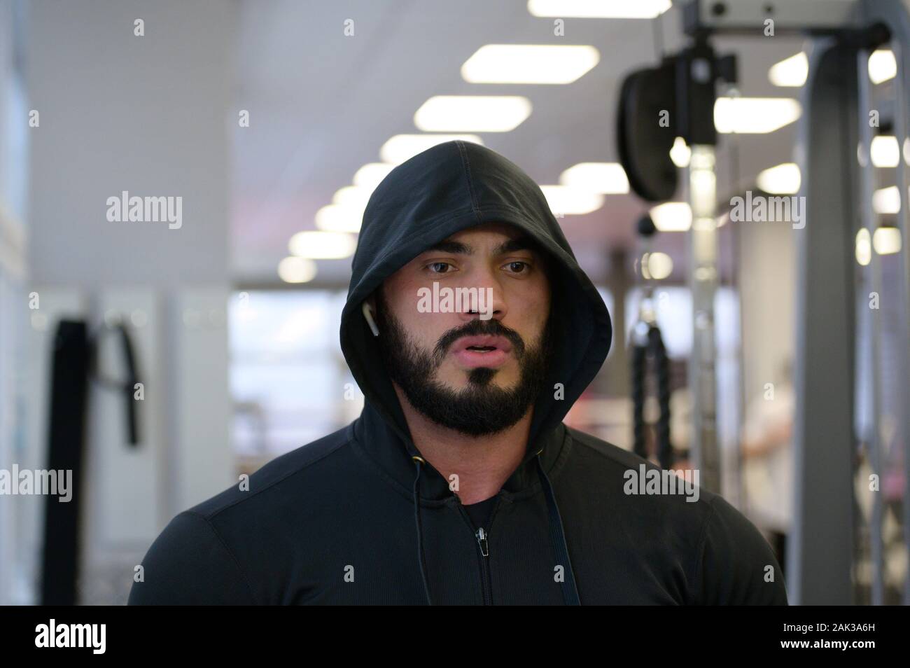 Motivation sport concept de jeune homme barbu in hoodie dans fitness sport avec l'esprit de concentration mentale Banque D'Images
