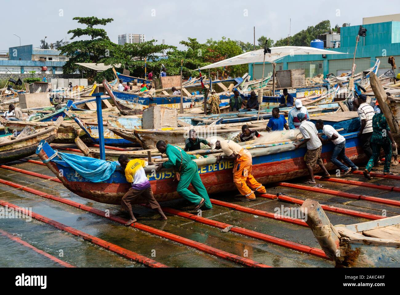 Bénin, Cotonou, le marché aux poissons, les pêcheurs se remettre leur bateau dans l'eau réparé Banque D'Images