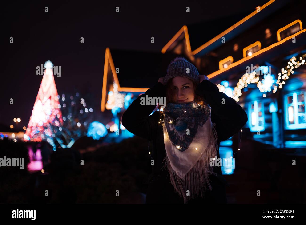 Portrait - jeune fille rousse attrayante de traîner dans le parc d'attractions avec des couleurs vives et des installations - fond attractions Banque D'Images