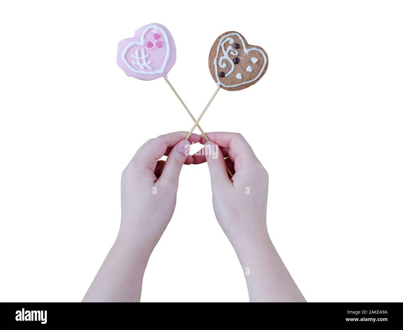 Woman's hands holding a Valentine cookies isolé sur fond blanc. Banque D'Images