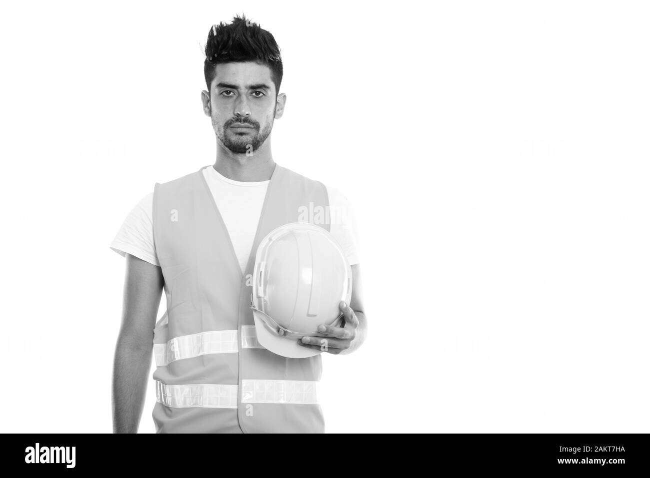Portrait de jeune homme persan construction worker holding hard hat Banque D'Images