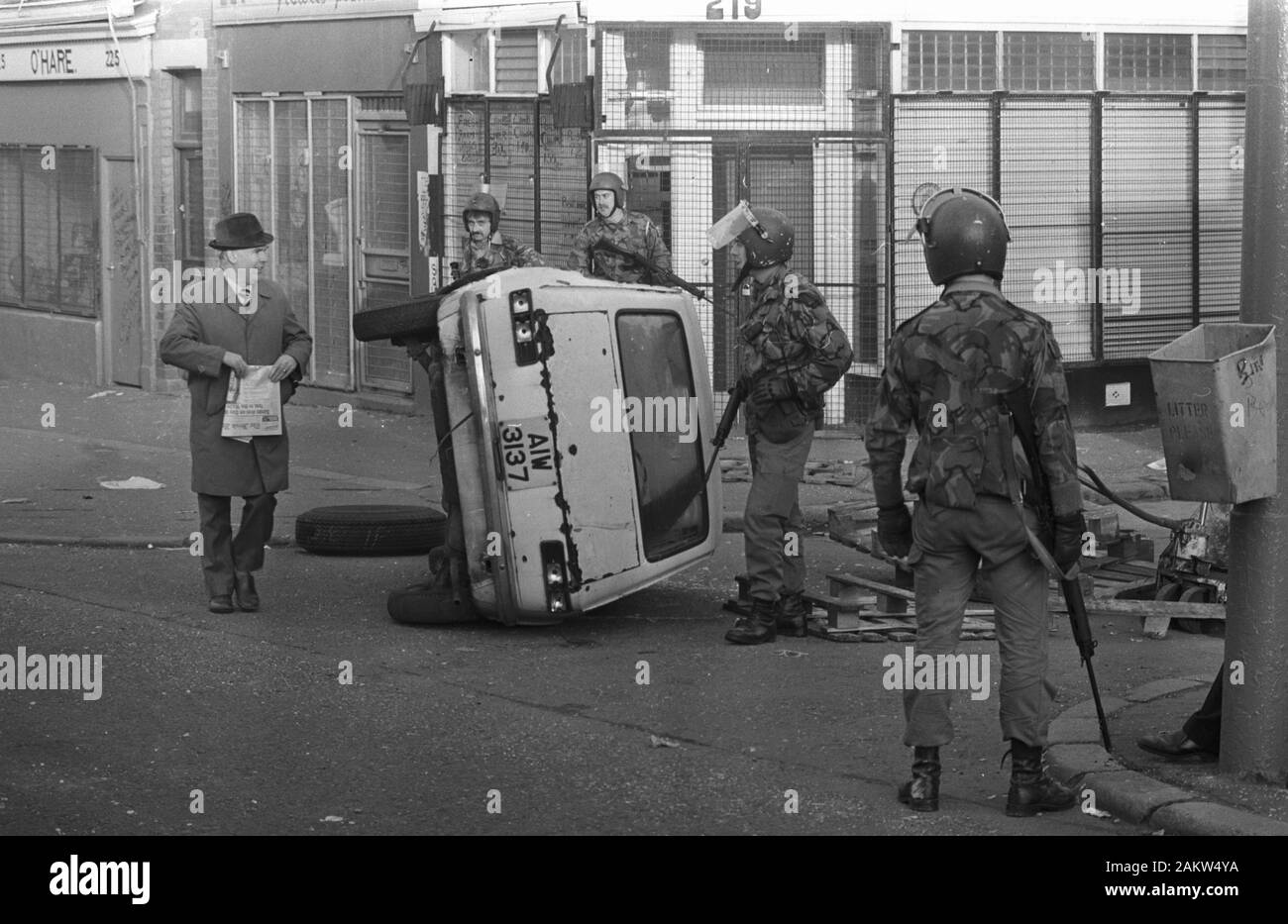 Les troupes en patrouille dans la région de Falls Road catholique de Belfast rencontrent un civil a renversé par une voiture qui forment une barricade pendant les émeutes dans les premières heures du matin. Des émeutes ont éclaté dans la ville peu après l'annonce de Bobby Sands, mort en prison labyrinthe. Banque D'Images
