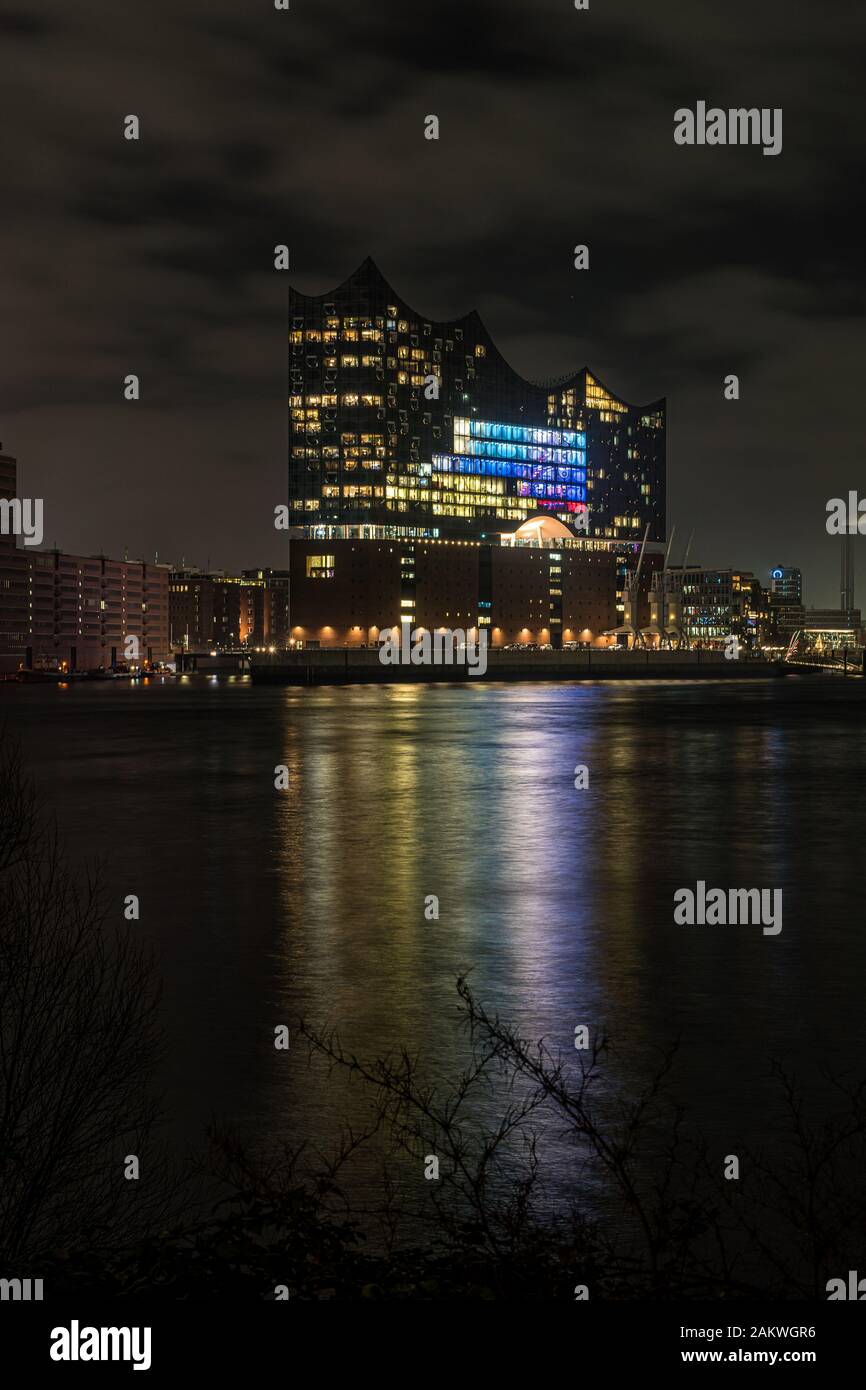 Nuit photo de l'Elbphilonie illuminée dans le port de Hambourg dans la ville de Hafen à la rivière Elbe avec quelques réflexions dans l'eau Banque D'Images