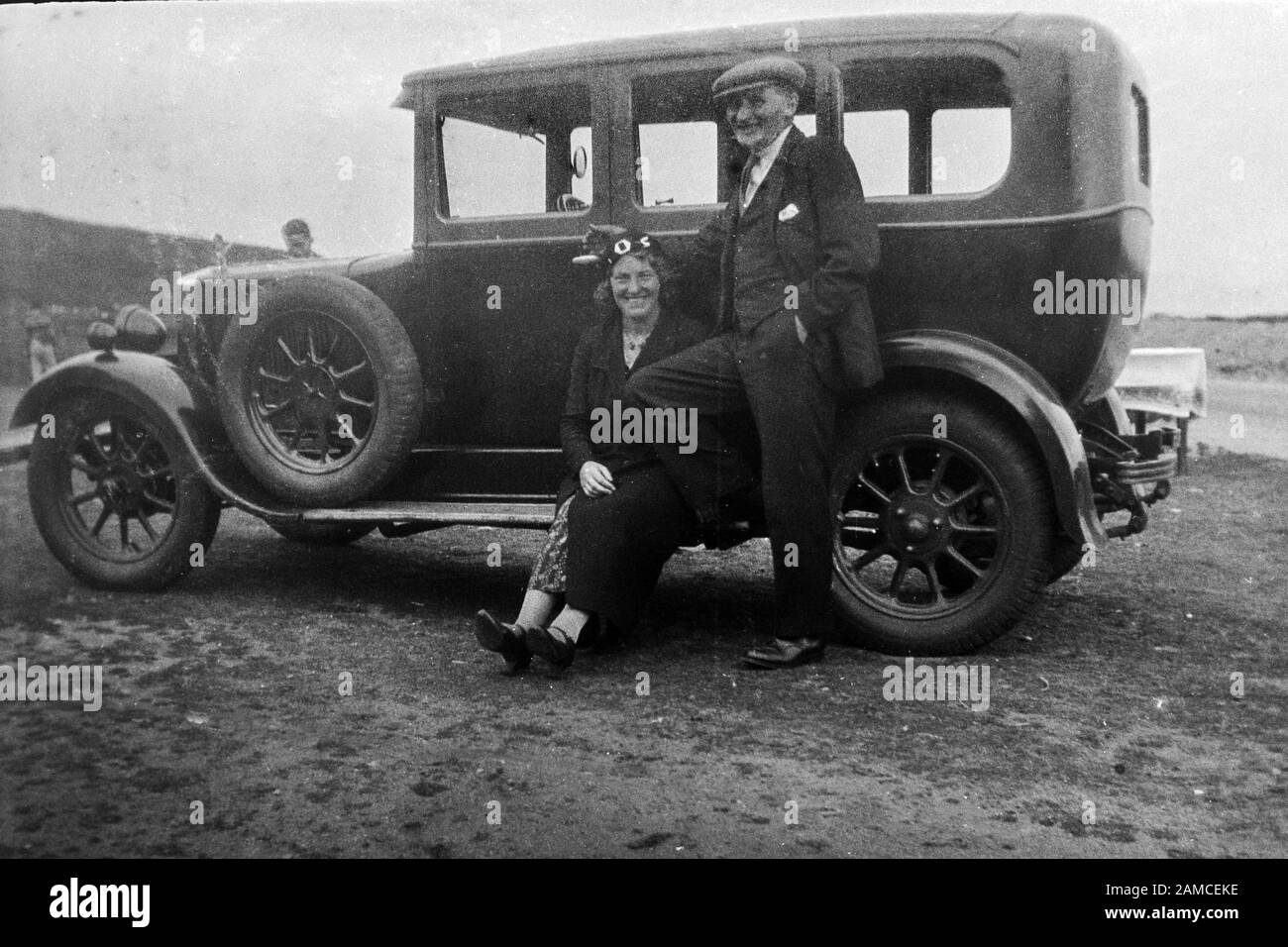 Archivez l'image d'un homme et d'une femme par une voiture, vers les années 1920 scannée directement à partir du négatif Banque D'Images