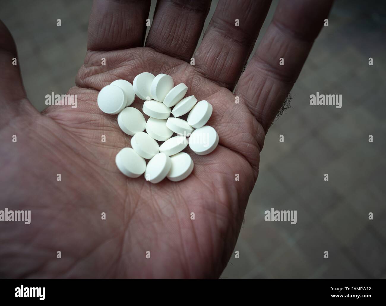homme mûr main tenant beaucoup de pilules blanches, concept de santé, overdose .. Banque D'Images