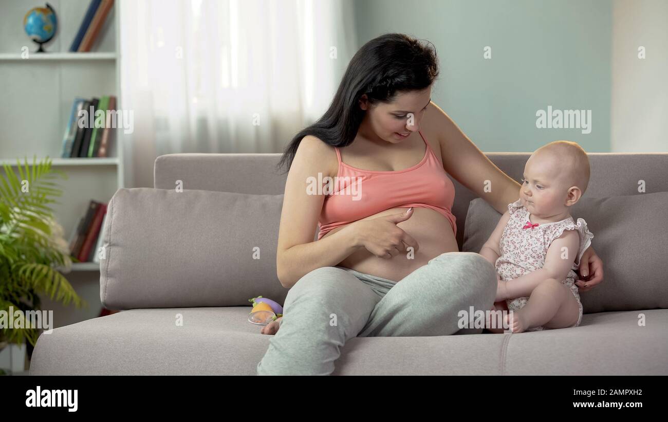 Femme En Train De Se Faire Une Grossesse De Toucher Son Gros Ventre Et De Parler A Son Bebe De Sa Sœur Photo Stock Alamy