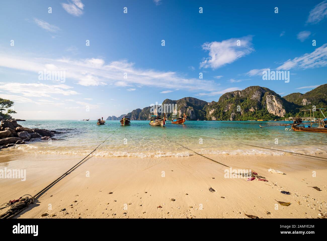 Bateaux longtail traditionnels en bois stationnée à une plage à Phi Phi Island. L'eau claire et propre plage. Banque D'Images