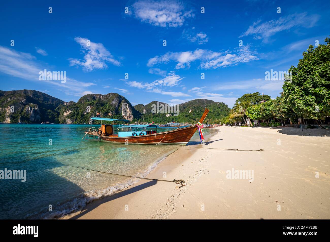 Bateaux longtail traditionnels en bois stationnée à une plage à Phi Phi Island. L'eau claire et propre plage. Banque D'Images