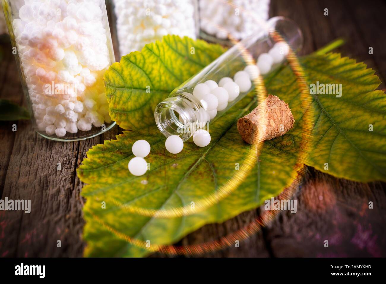 Globules de sucre lactose homéopathiques sur feuille avec le flacon en verre Banque D'Images