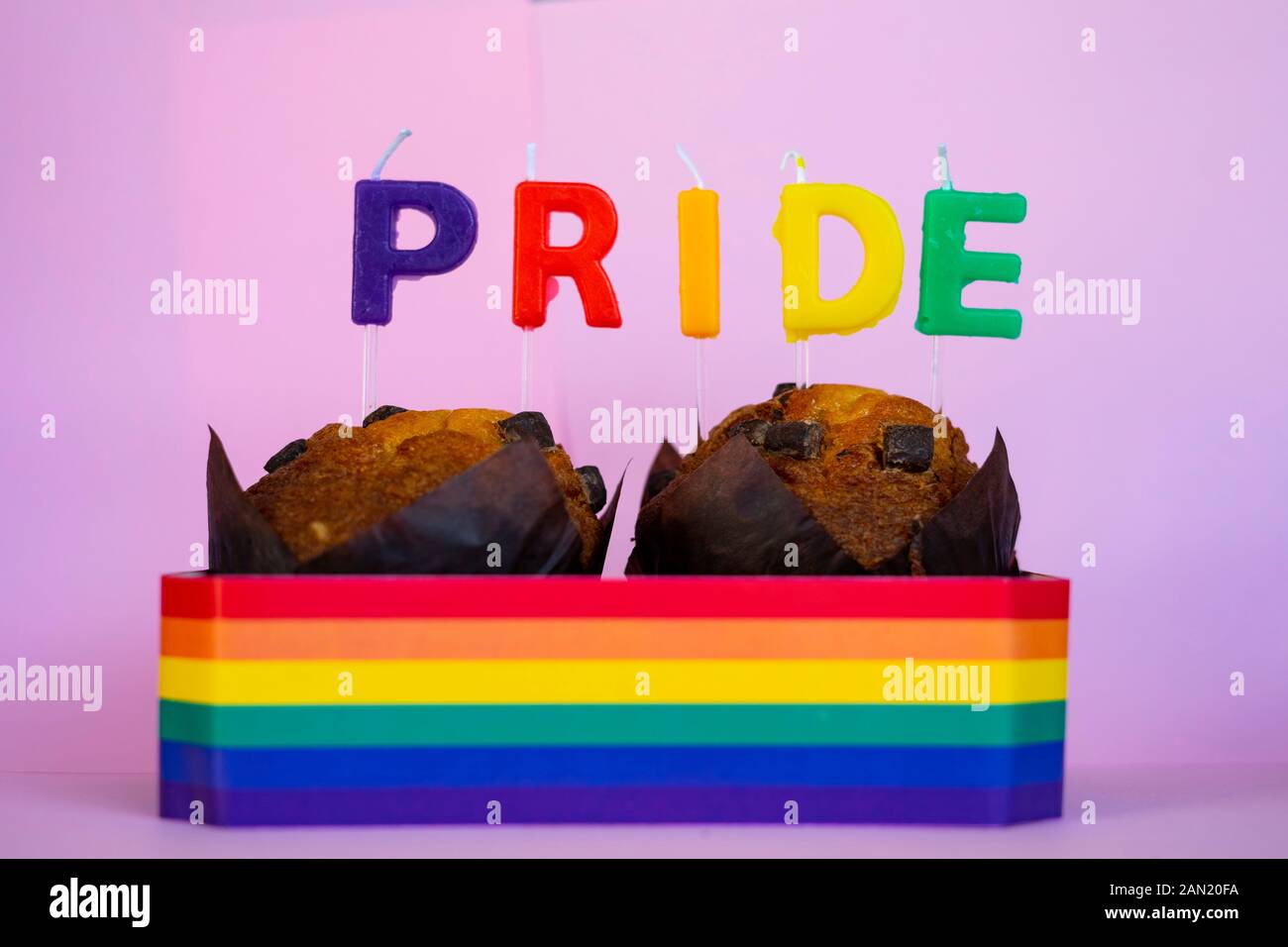 Deux muffins avec des bougies et la fierté d'un drapeau. Célébration de la fierté concept. Banque D'Images