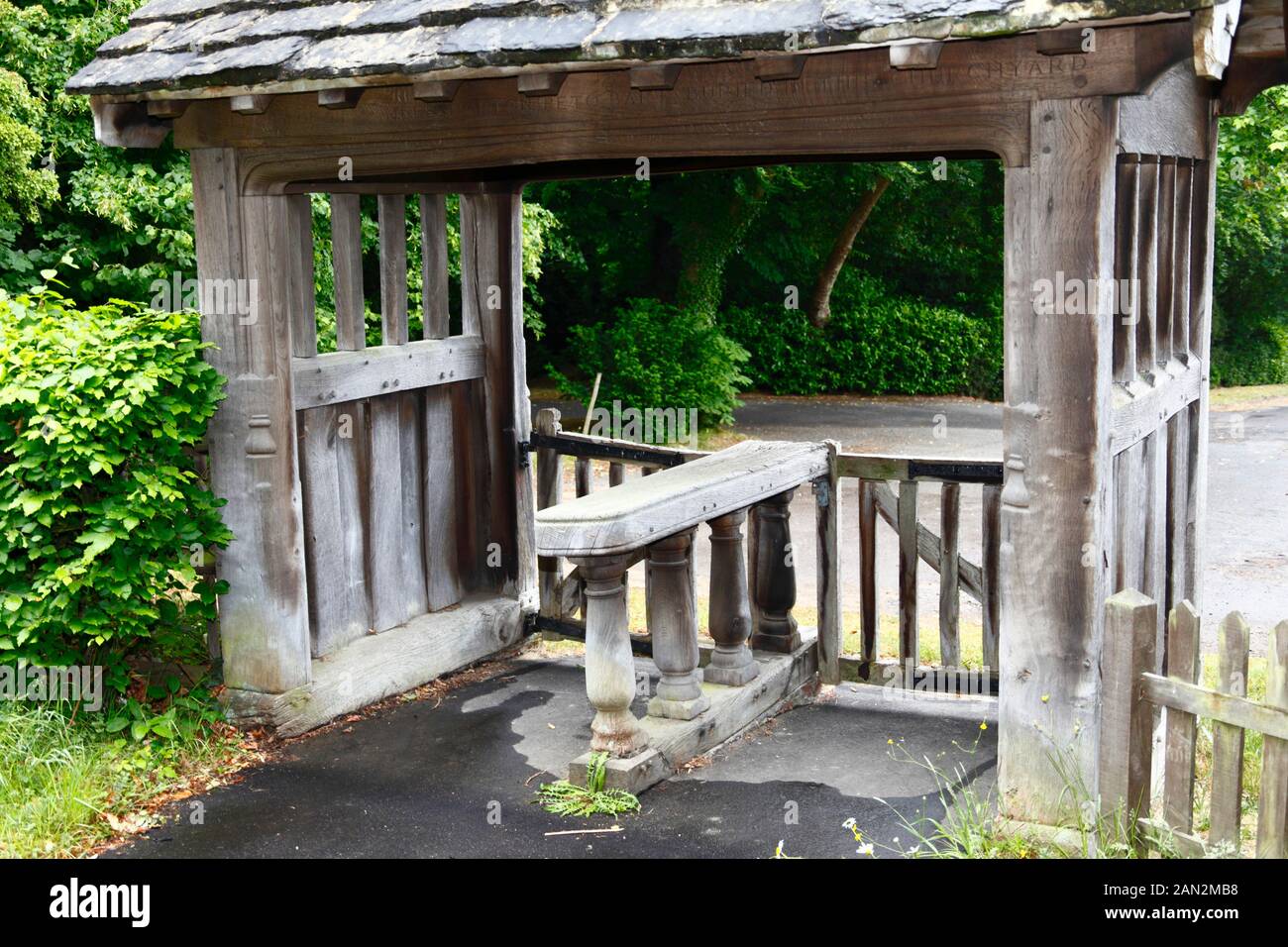 Détail de la porte de lychgate en bois avec une dalle en bois pour reposer le cercueil à l'entrée de l'ancienne église paroissiale de St Pierre, Pembury, Kent, Angleterre Banque D'Images