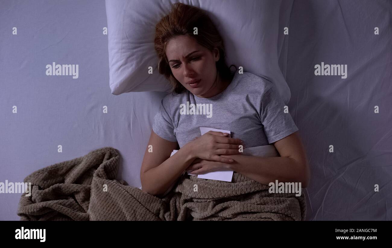 Femme en colère qui crie dans lit, holding certificat de divorce, la  douleur de la perte de mari Photo Stock - Alamy