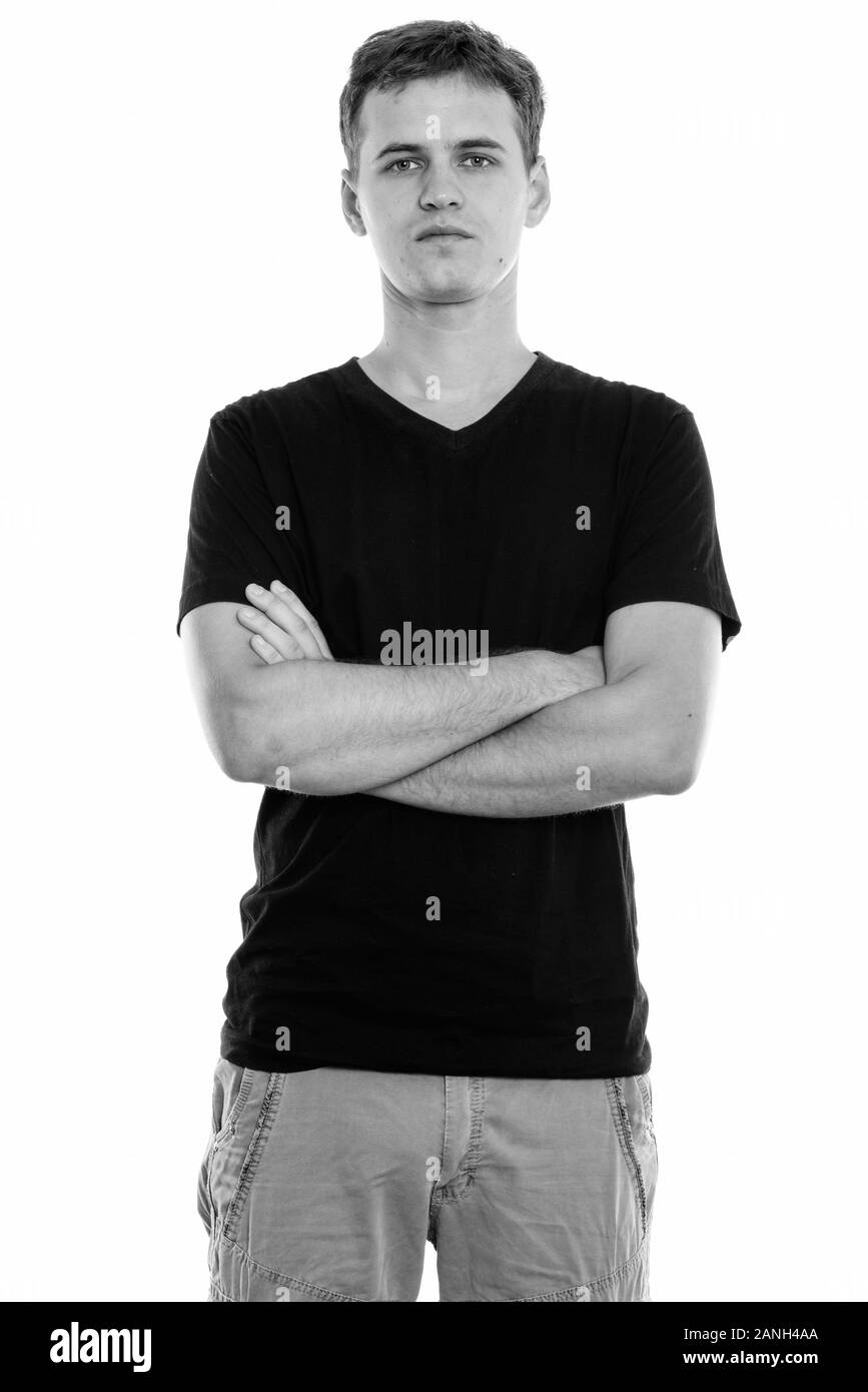 Studio shot of young man standing with arms crossed Banque D'Images Studio shot of young man standing with arms crossed Banque D'Images