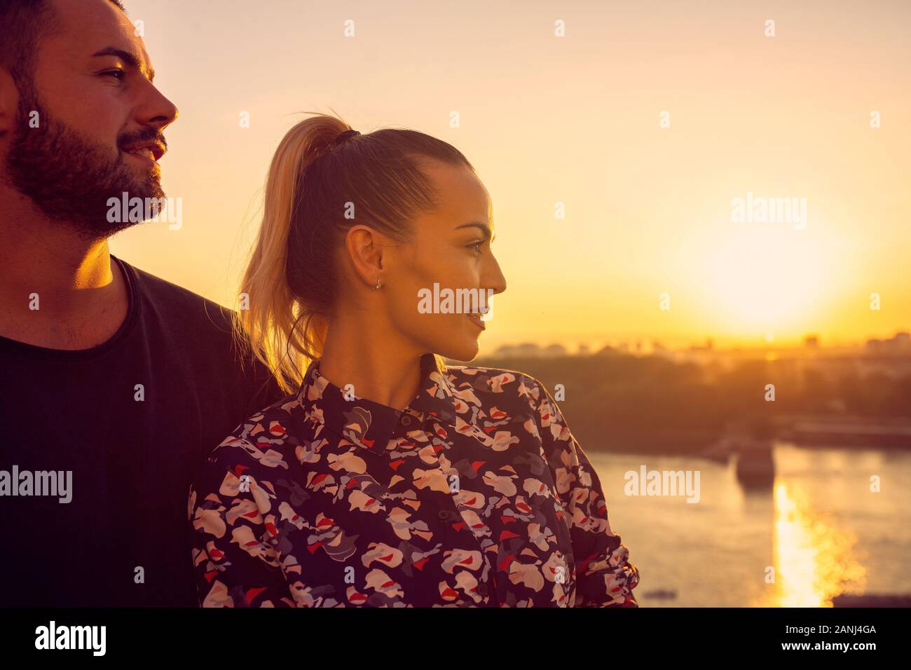 Smiling couple amour datant de plein air dans le coucher du soleil Banque D'Images