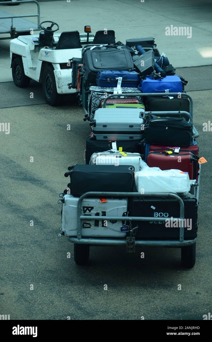 les manutentionnaires de bagages d'aéroport chargent les bagages et le fret  sur le jet passager Photo Stock - Alamy