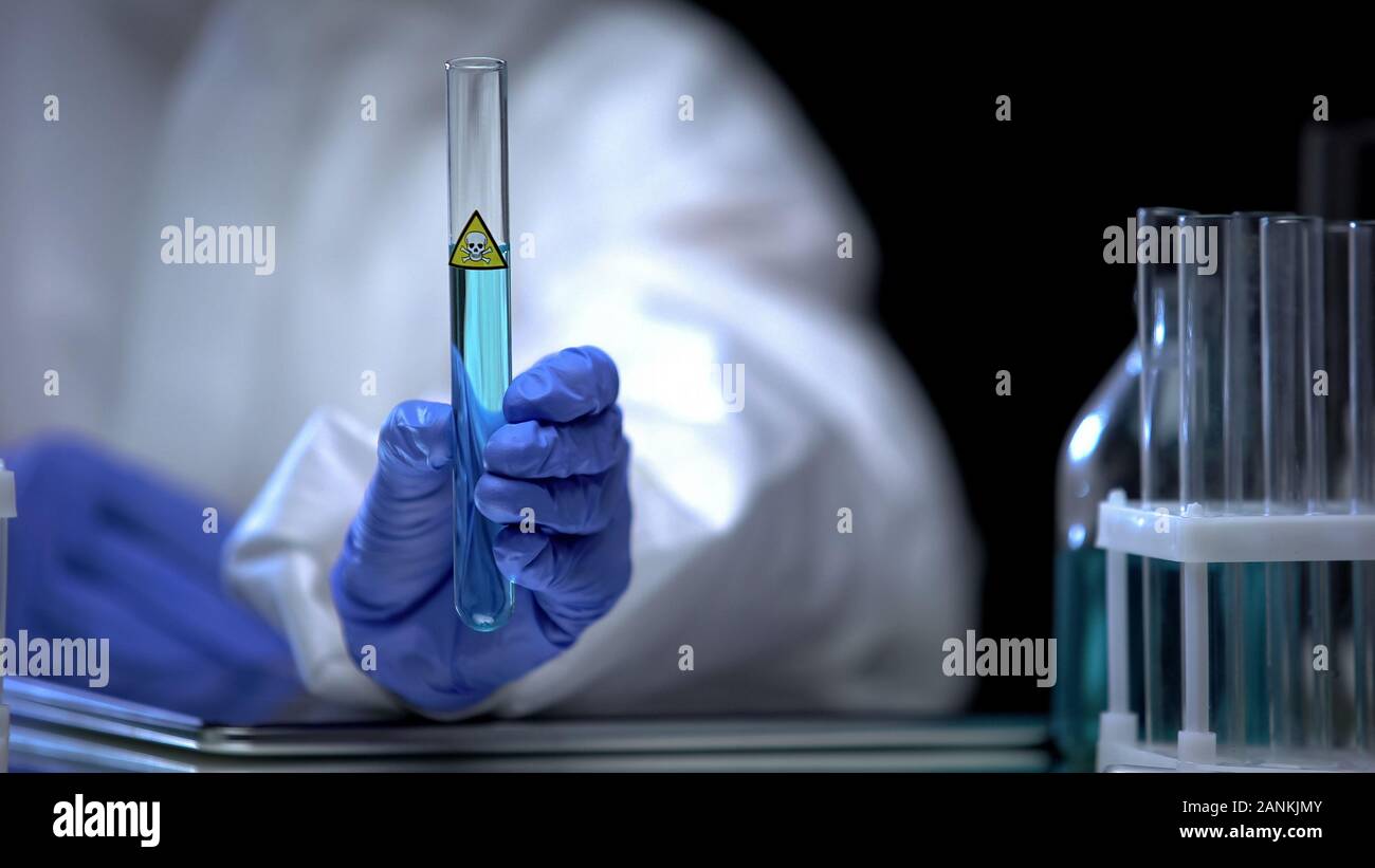 Travailleur de laboratoire chimique montrant tube à essai avec liquide toxique, l'examen Banque D'Images