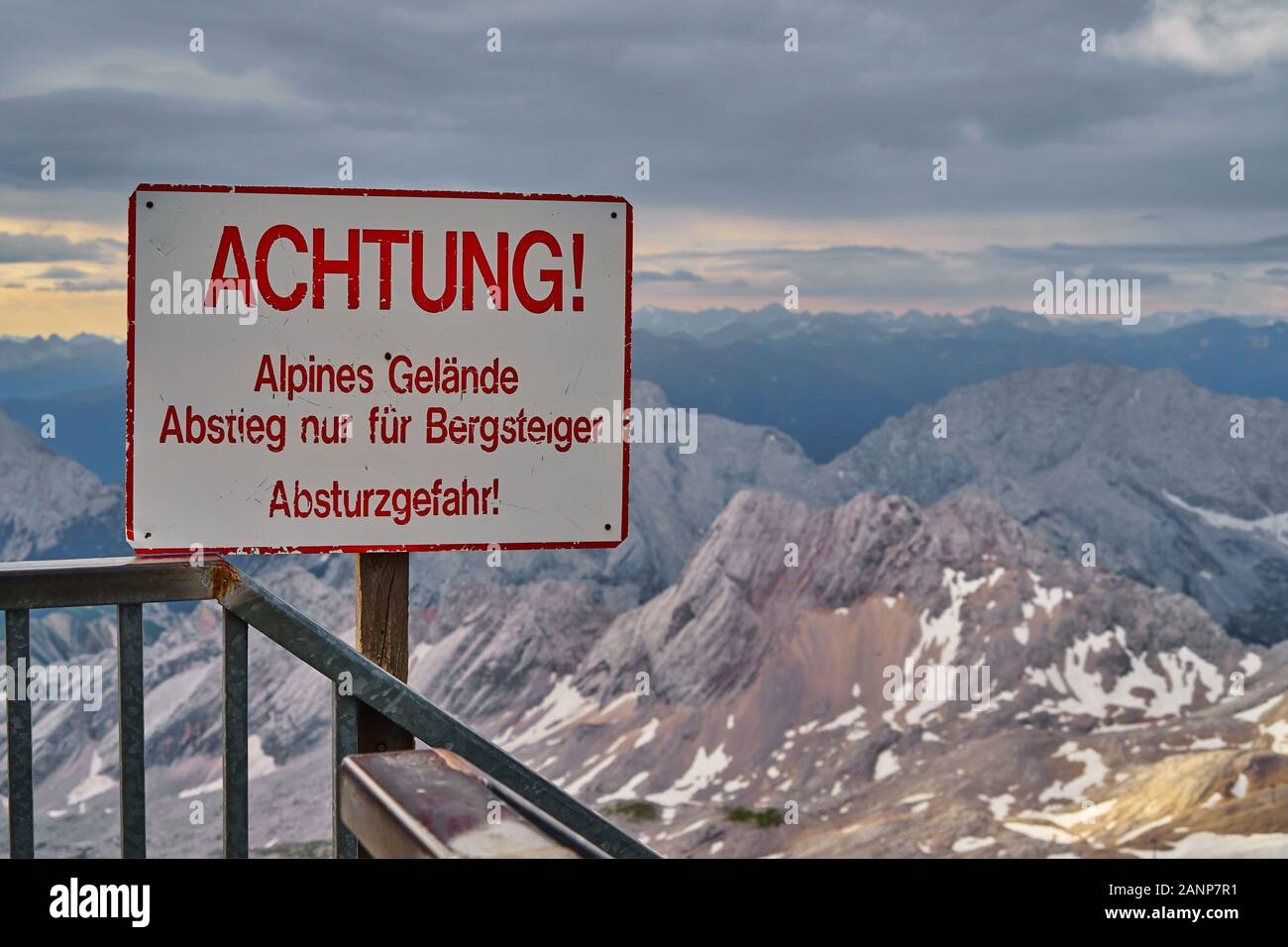 Inscrivez-vous sur un sommet dans les Alpes avec l'inscription : 'Prendre soin. Terrain alpin, descente uniquement pour les alpinistes, danger de chute'. Banque D'Images