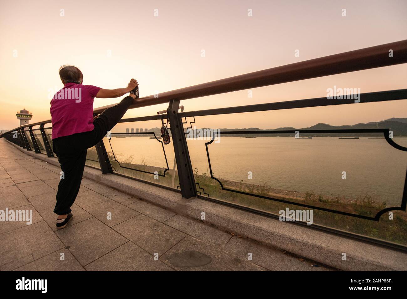 Tai Chi à l'aube dans la ville chinoise de Zhaoqing - populaires parmi les habitants qui se rassemblent, comme le soleil se lève. Ici, les personnes âgées pratiquer l'art. Banque D'Images