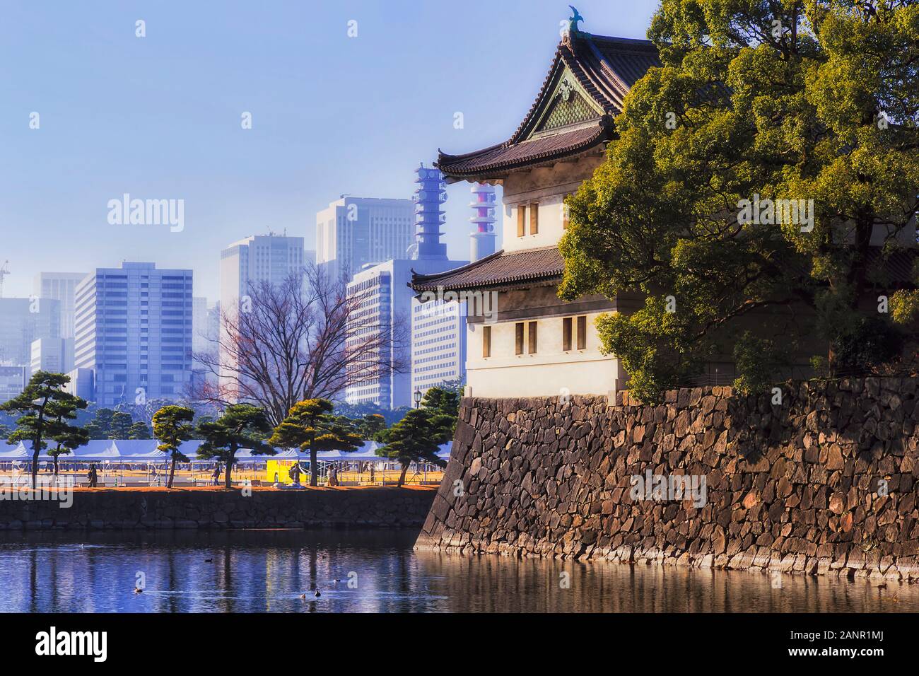 Le palais impérial et le jardin au milieu de la ville de Tokyo. Site historique entouré de douves remplies d'eau contre les tours d'affaires moderne sous blue sk Banque D'Images