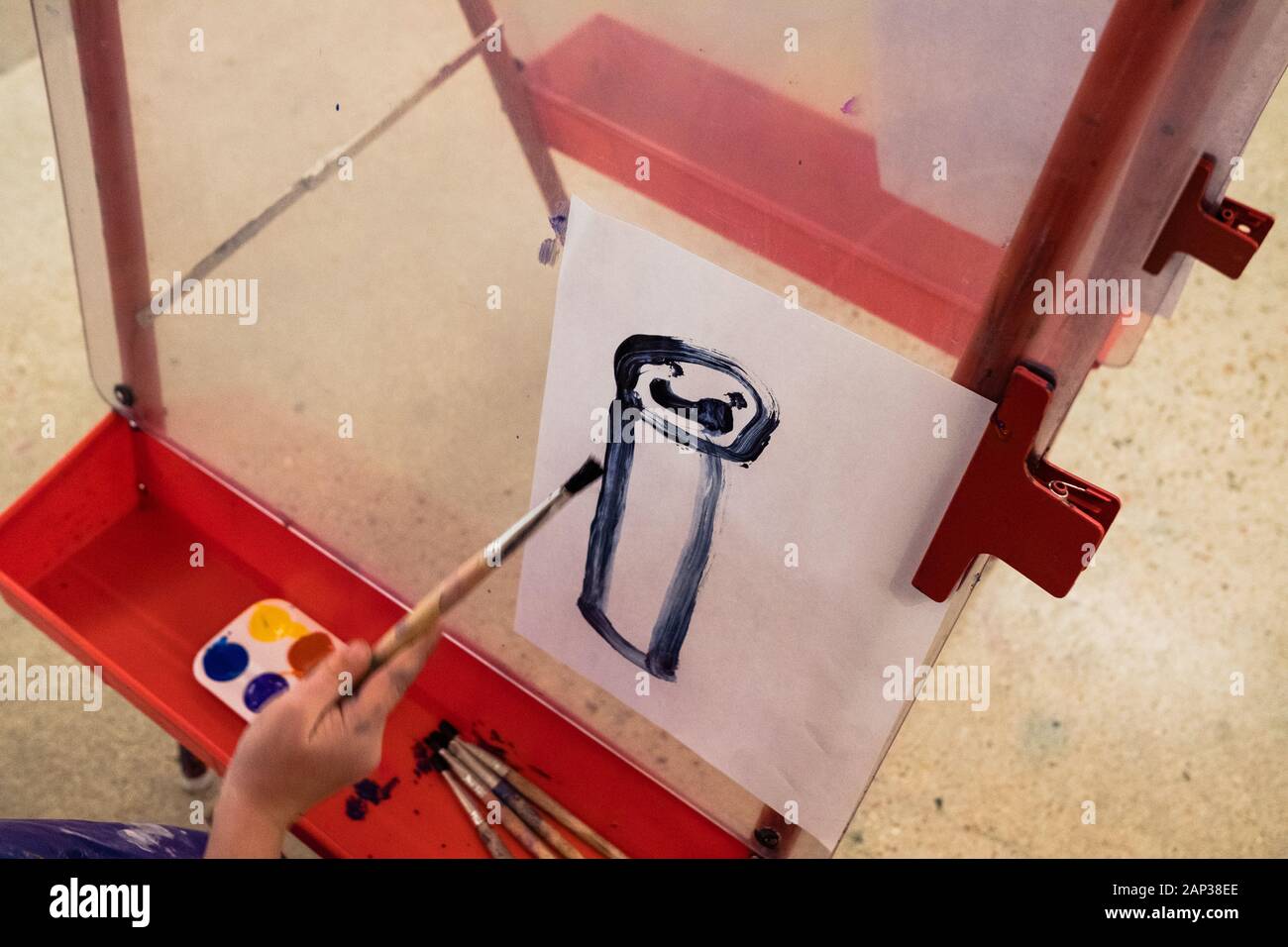 enfant peint un portrait d'une personne dans un studio d'art Banque D'Images