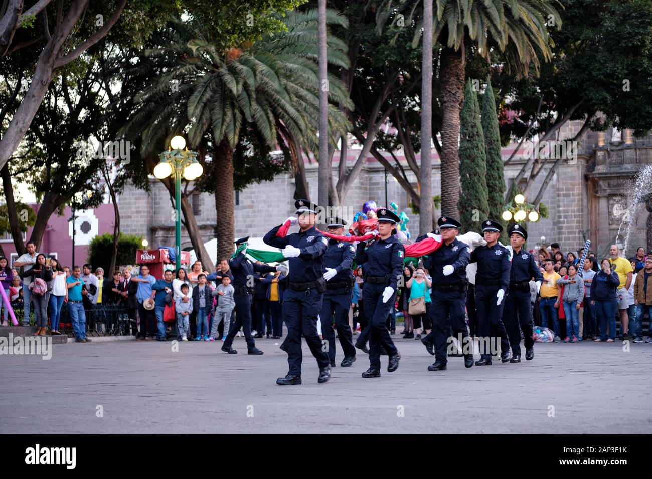 Puebla, Mexique. Descente de cérémonie du drapeau mexicain par la police municipale en place centrale Banque D'Images