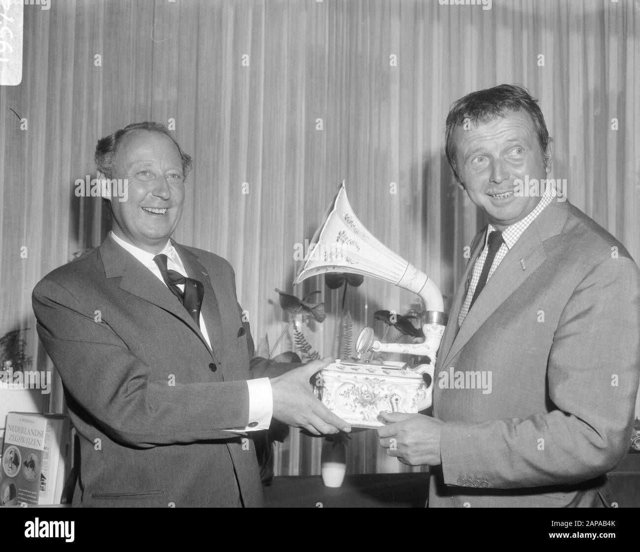 Réception à la suite du vingtième anniversaire de la société de disques gramophone N.V. Bovema à l'hôtel Hilton d'Amsterdam Description: M. G.M. van Oord (dir. Bovema (l) montre Toon Hermans un gramophone en porcelaine rare Date: 19 septembre 1966 lieu: Amsterdam, Noord-Holland mots clés: Artistes, comédiens, sociétés de disques gramophone, réceptions Nom personnel: Hermans, Toon, Oord, G.M. van Banque D'Images