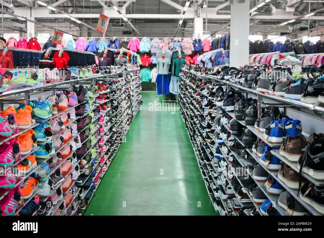 Chelyabinsk, Russie - septembre 2019: De belles sneakers sportives lumineuses se tiennent sur des rayonnages dans un magasin de vêtements et de chaussures. En arrière-plan sont des échantillons de Banque D'Images