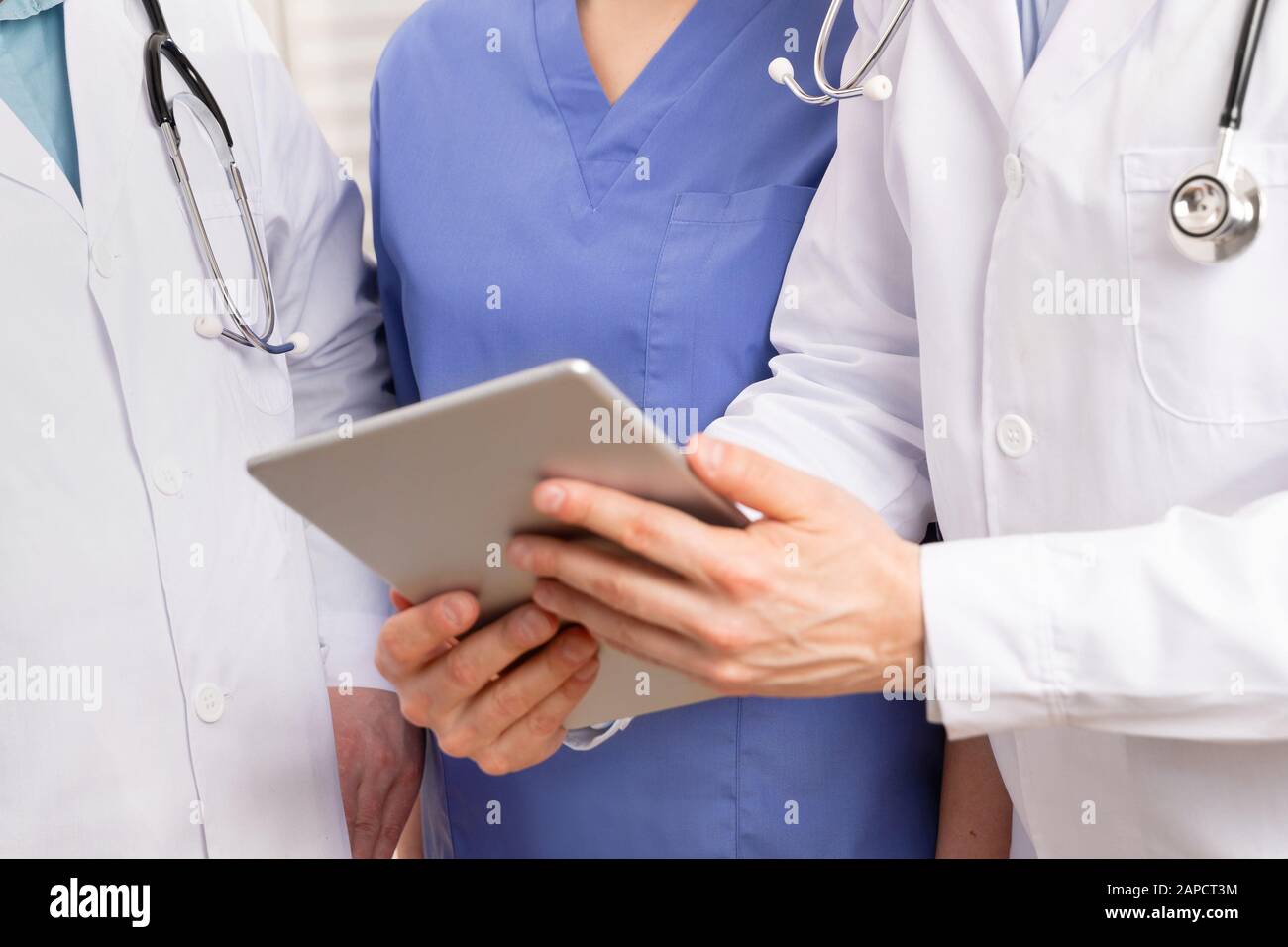 Médecin de l'équipe médicale discutant du rapport du patient sur l'ordinateur tablette de l'hôpital Banque D'Images