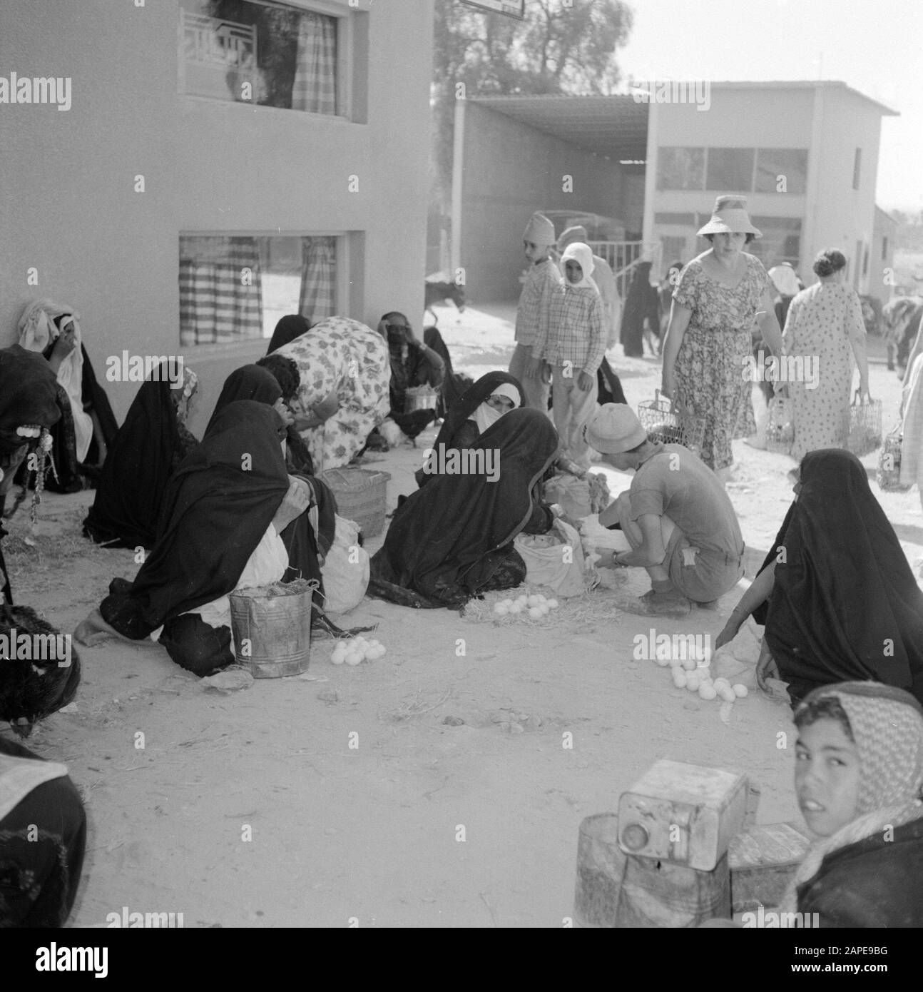 Israël 1960-1965: Bedouin in in Beershewa (Beer Sheva) Description: Bedouin femmes en costume traditionnel avec enfants sur le marché tout en offrant des oeufs à vendre Date: 1 janvier 1960 lieu: Bersheba, Israël mots clés: Bedouins, oeufs, commerce, costume, marchés Banque D'Images