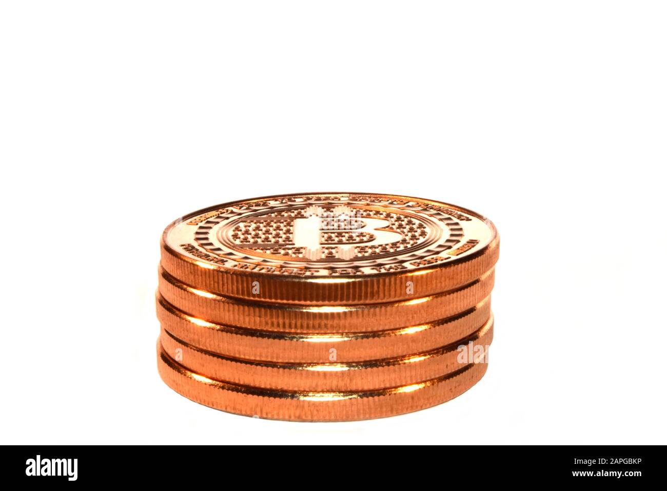 Gros plan des bitcoins l'un sur l'autre sous le s'allume sur fond blanc Banque D'Images