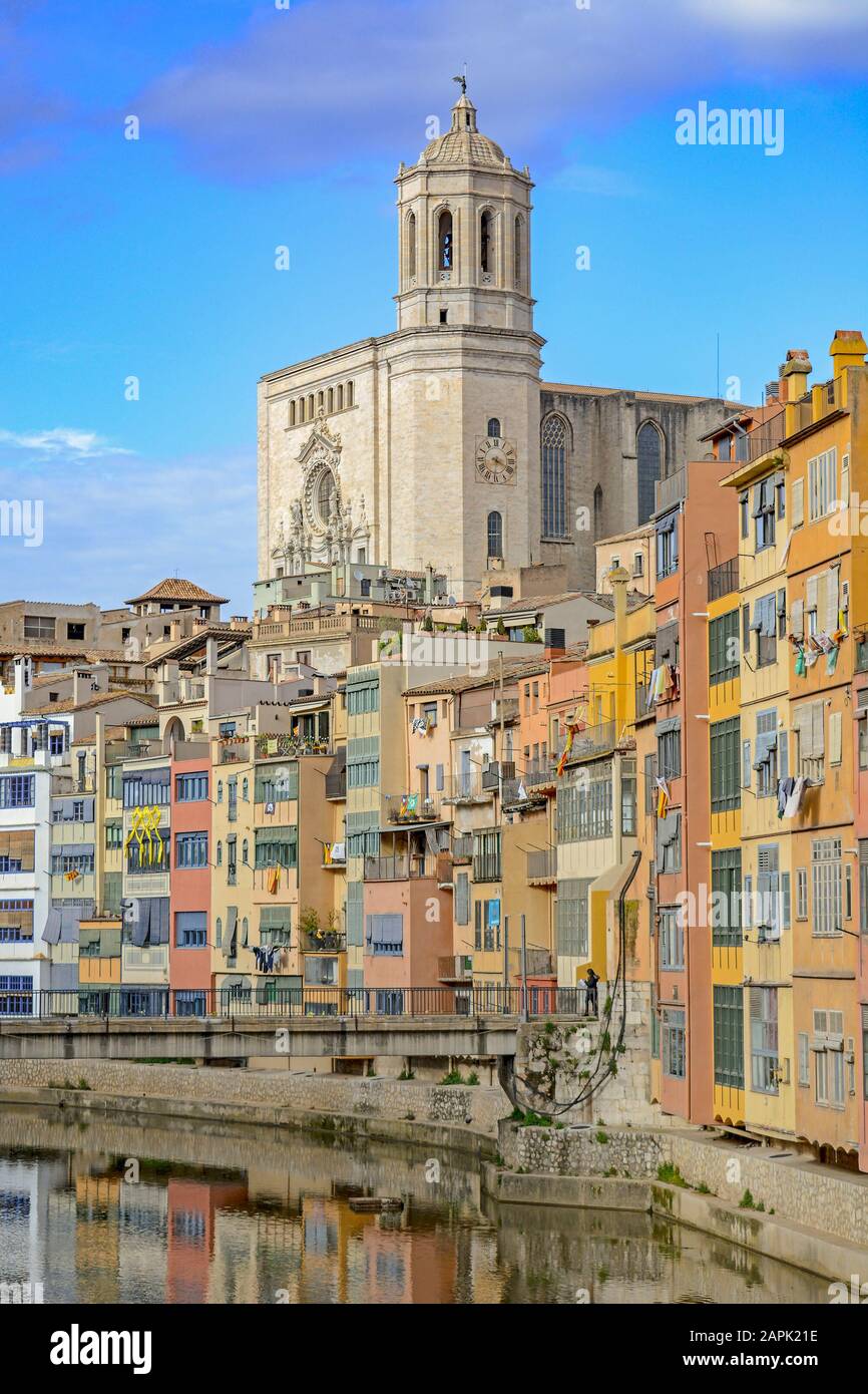 Maisons jaunes et oranges colorées et cathédrale St Mary à Gérone, Catalogne, Espagne, reflétées dans l'eau de la rivière Onyar. Banque D'Images