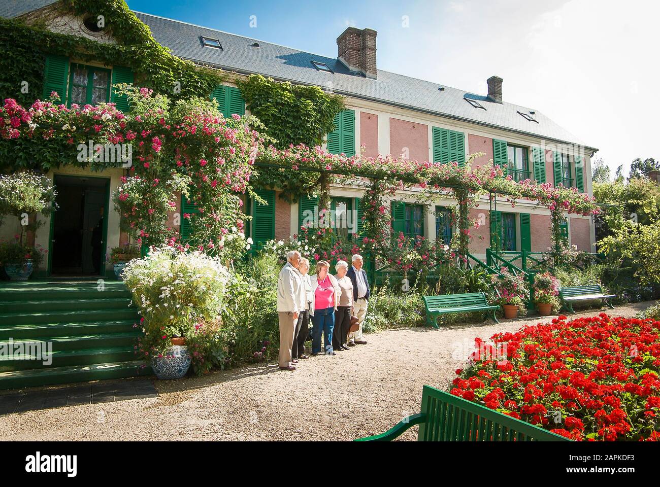 Un groupe de touristes pose devant la maison de Mone à Giverny France pour une photo de groupe lors d'une journée ensoleillée Banque D'Images