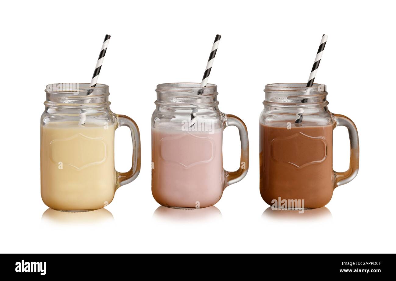 Bananiers, fraises et milkshakes au chocolat dans des verres En Pot Mason, avec pailles en papier, isolés sur fond blanc avec ombre portée Banque D'Images