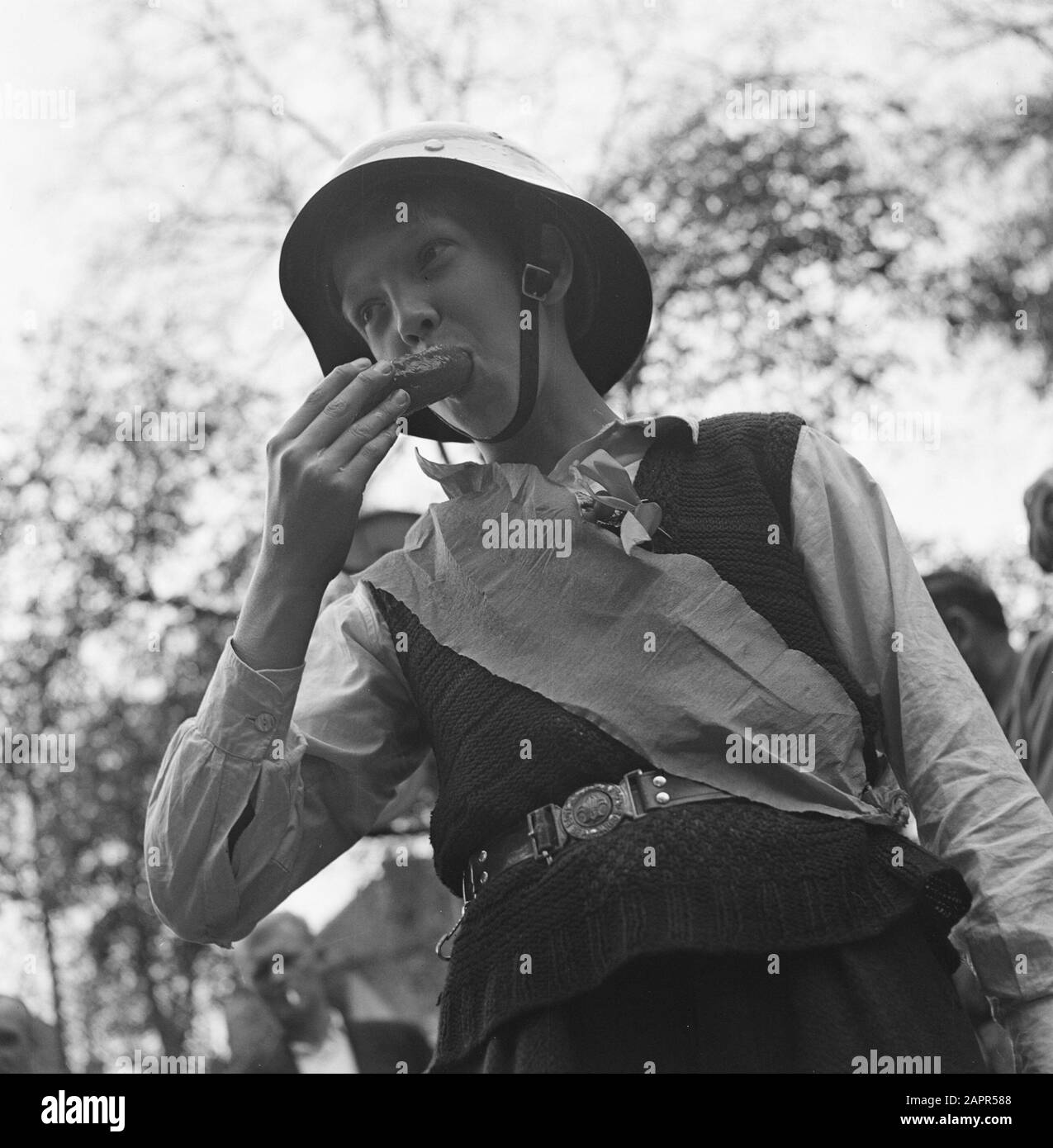 Les divertissements populaires à Amsterdam. Rép. Des diverses festivités après la libération dans la capitale [Boy with casque mange quelque chose] Date: 28 juin 1945 lieu: Amsterdam, Noord-Holland mots clés: Festivals de libération, deuxième Guerre mondiale Banque D'Images