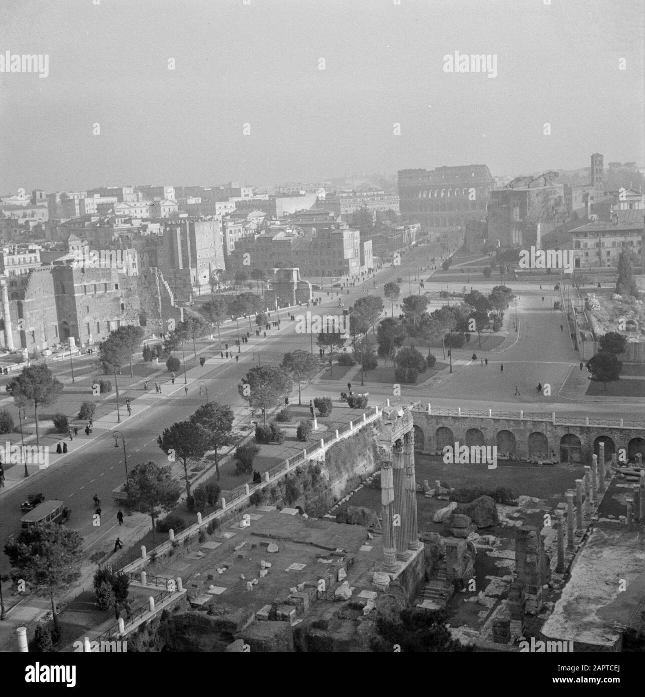 Rome: Visite de la ville vue du Forum romain avec en arrière-plan l'Amphithéâtre Flavian ou le Colisée Date: Décembre 1937 lieu: Italie, Rome mots clés: Archéologie, bâtiments, piliers, ruines, sculptures de ville, rues, théâtre Banque D'Images