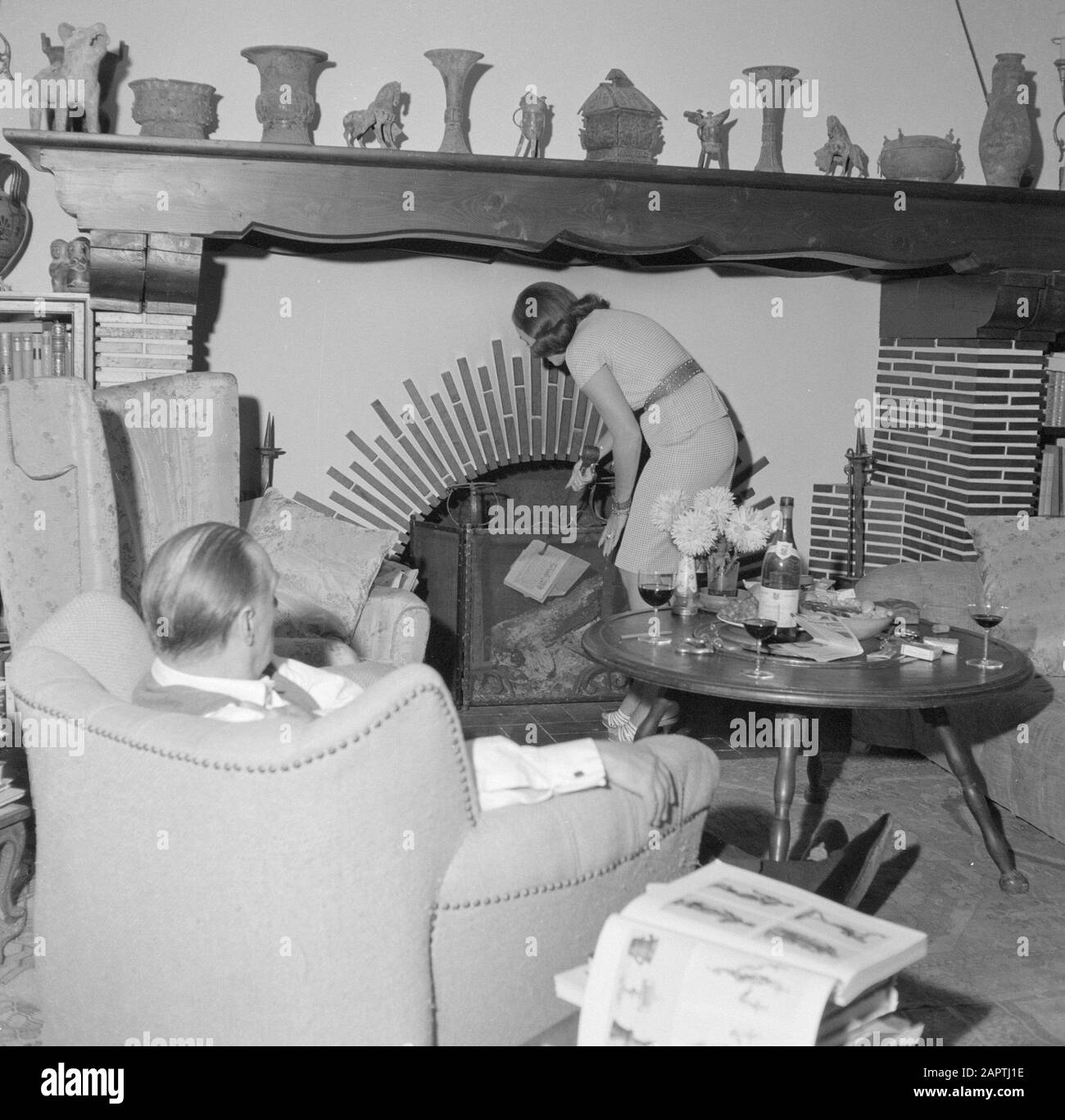 Visite de l'auteur allemand Erich Maria Remarque et de l'actrice américaine Paulette Goddard dans leur villa à Porto Ronco, Suisse Le couple dans leur salon dans la villa à Porto Ronco. Erich Maria Remarque se trouve dans un fauteuil, sa femme Paulette Goddard fait feu dans la cheminée Date: Octobre 1961 lieu: Lac majeur, Suisse mots clés: Acteurs, intérieurs, écrivains, maisons Nom personnel: Goddard, Paulette, Remarque, Erich Maria Banque D'Images