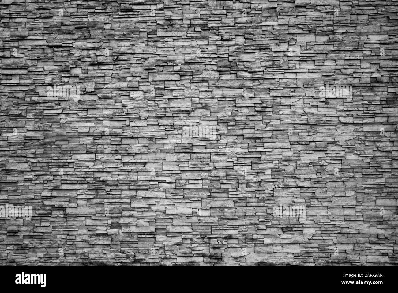 Résumé motifs irréguliers de mur de pierre en noir et blanc comme arrière-plan ou textures Banque D'Images