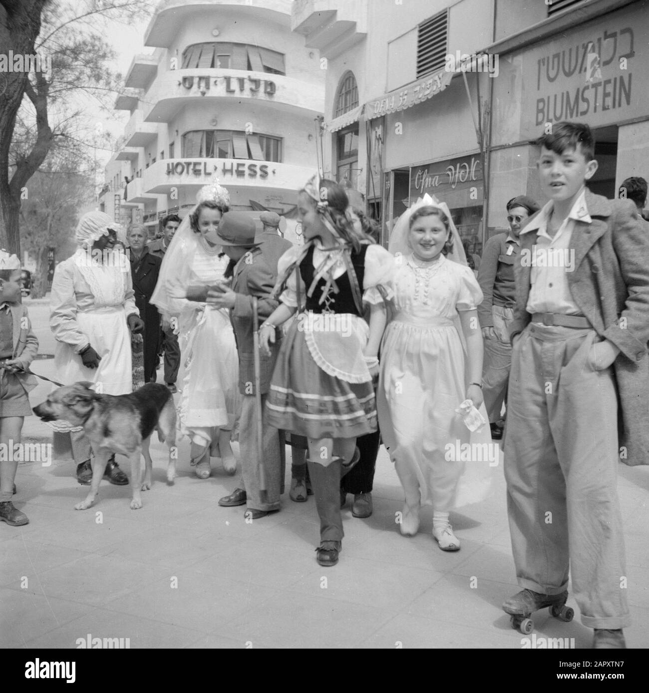 Israël 1948-1949: Tel Aviv Habille des enfants avec des adultes dans la rue à l'Hôtel Hess à tel Aviv à l'occasion de la célébration de purim Date: 1948 lieu: Israël, tel Aviv mots clés: Hôtels, religion juive, enfants, vacances religieuses Banque D'Images