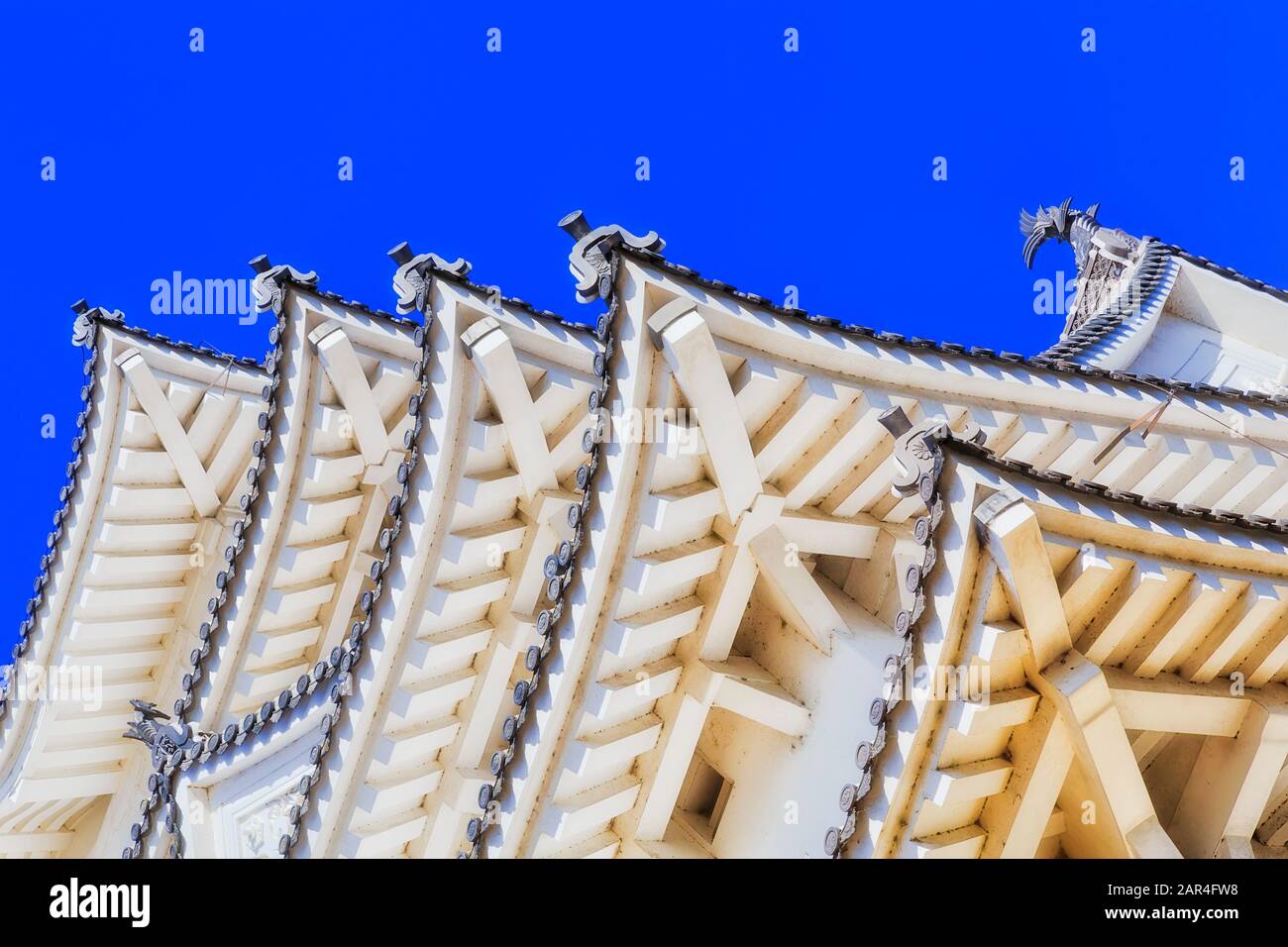 Toit japonais traditionnel sur le château historique de shogun contre le ciel bleu par une journée ensoleillée - sous la structure et les poutres. Banque D'Images