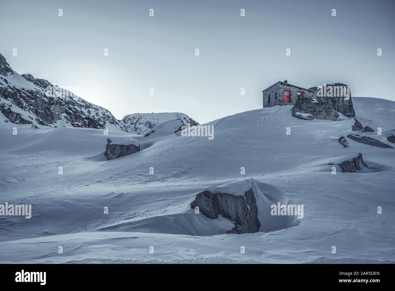 La glace et la neige couvraient une petite cabane d'abri en pierre, debout au sommet du pic en hiver Banque D'Images