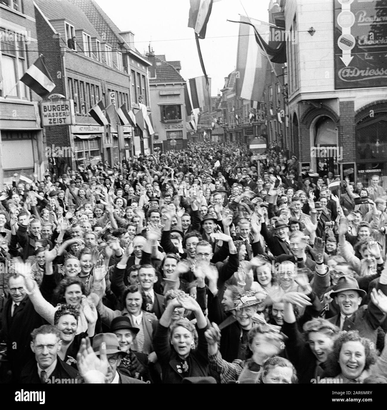 Beschrijving: Een uitzinnige menigte verwelkomt de Geallieerden (49e Canadian infanterie divisière) bij hun intocht à Utrecht. Banque D'Images